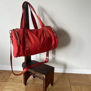 Adorable mini duffle in hot orange! Bag made by State.